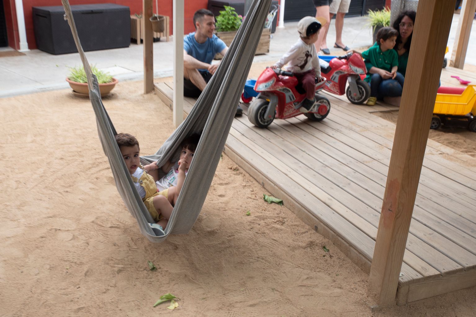 Un niño se mece en una tumbona de la Guardería Municipal del Poblenou durante una de las jornadas de patios abiertos.