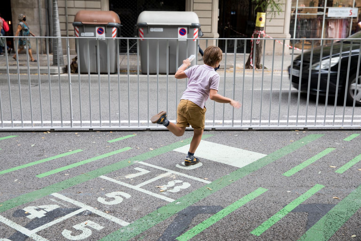 Nen jugant a la xarranca pintada al paviment de la zona pacificada de l’Escola Pia Balmes