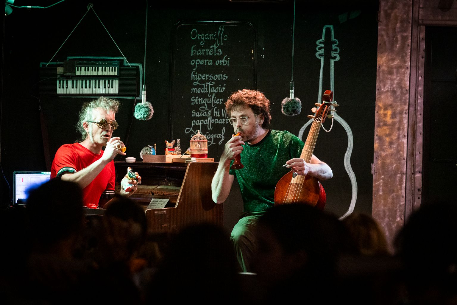 Els músics David Codina i Pau Marcos, del grup Els Mals Endreços, toquen uns xiulets durant l'espectacle 'Orelles' en el marc de la Biennal de Pensament 2024