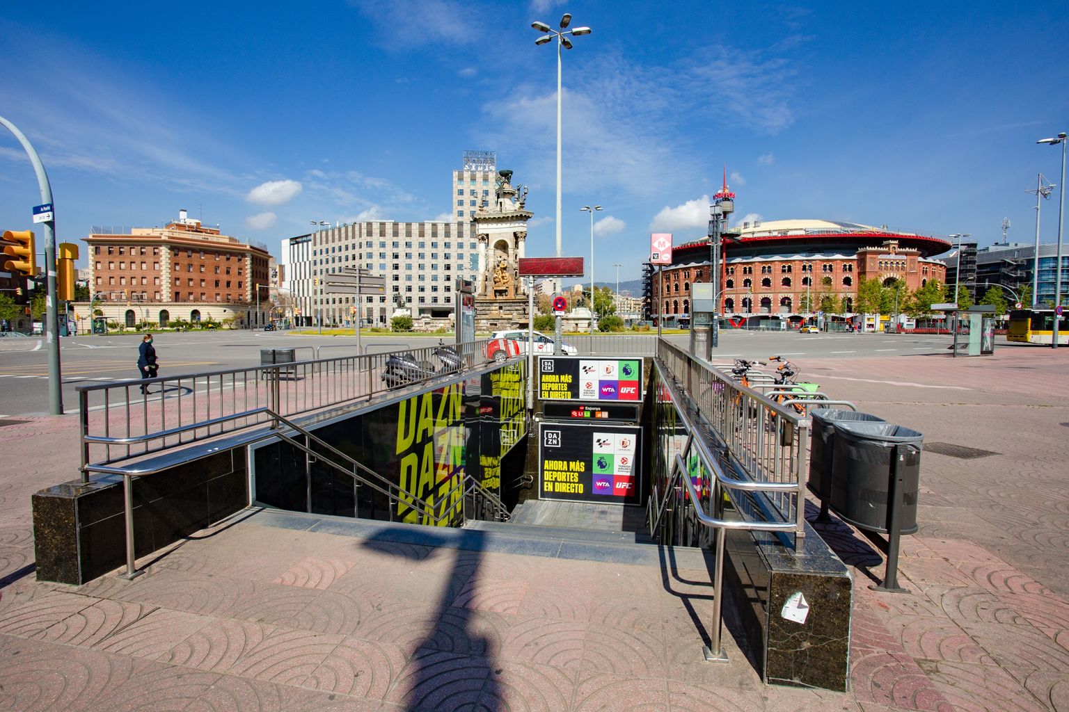 Sortida del metro a l’avinguda de Maria Cristina. Amb la plaça d’Espanya i el Centre Comercial de Les Arenes al fons. Districte de Sants-Montjuïc. Barri del Poble-sec