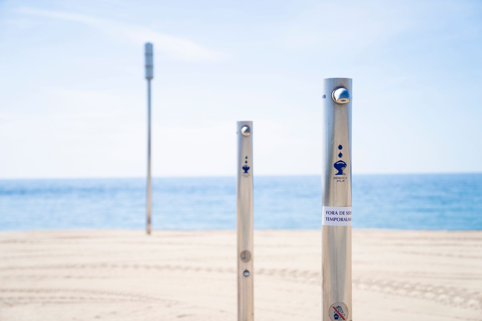 Dutxes de la Platja del Bogatell amb un cartell que indica que estan fora de servei temporalment