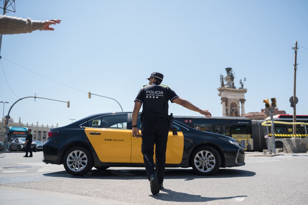 Un agent de la Guàrdia Urbana dirigeix el trànsit de plaça d'Espanya el dia de l'apagada general