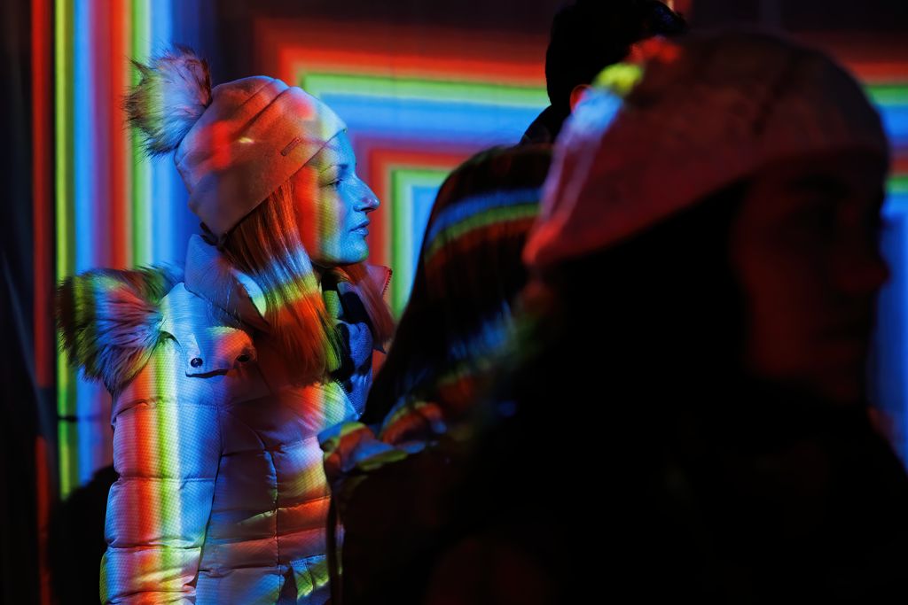El joc de llums de colors de la instal·lació “ATN”, de l'ESDI, es projecta sobre una de les visitants