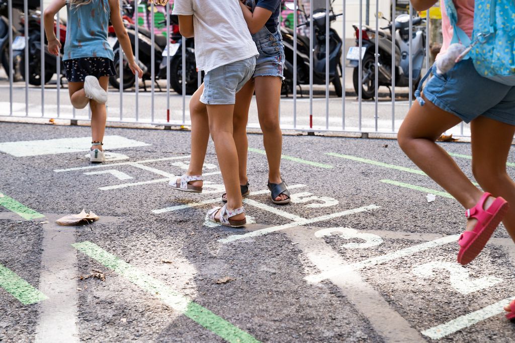 Infants jugant a la xarranca a la zona pacificada davant de l’Escola l’Univers